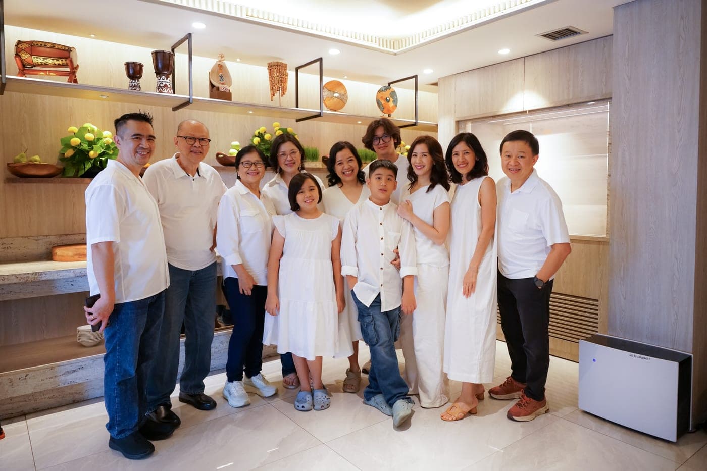 Extended family in white posing together indoors